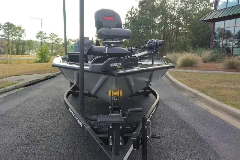 Slide: The Image of 2026 Tracker Pro Team 195 boat on trailer, parked outdoors near trees. - 5