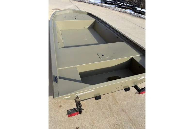 Slide: The Image of 2026 Tracker Grizzly 1648 Utility boat on trailer, parked on concrete surface. - 2
