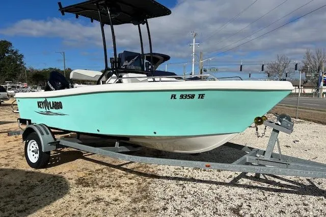 The Image of 2022 Key Largo 1800 Center Console boat on trailer, light blue hull, parked outdoors. - 2