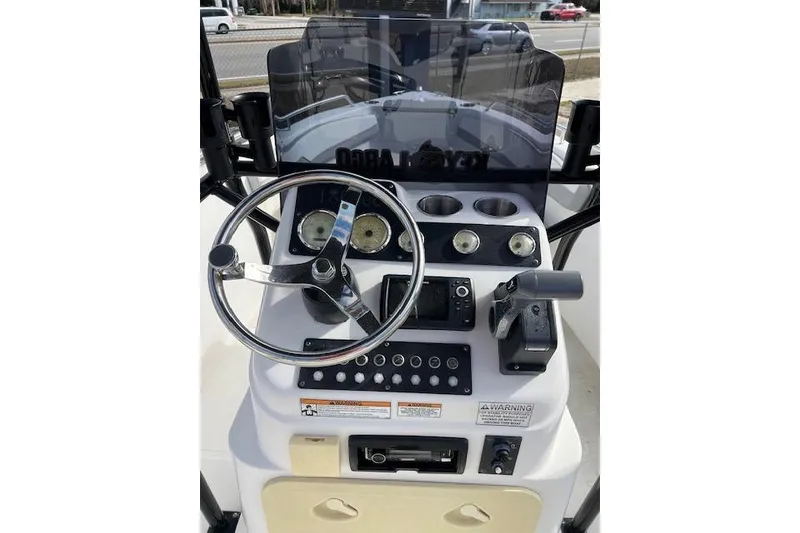 Slide: The Image of 2022 Key Largo 1800 Center Console boat dashboard with steering wheel and controls. - 6