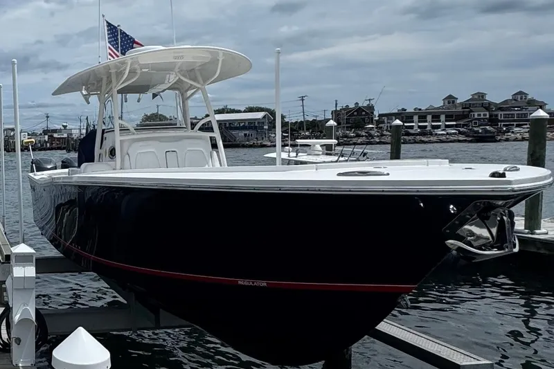 The Image of 2018 Regulator 34SS boat docked, featuring sleek design and American flag. - 0