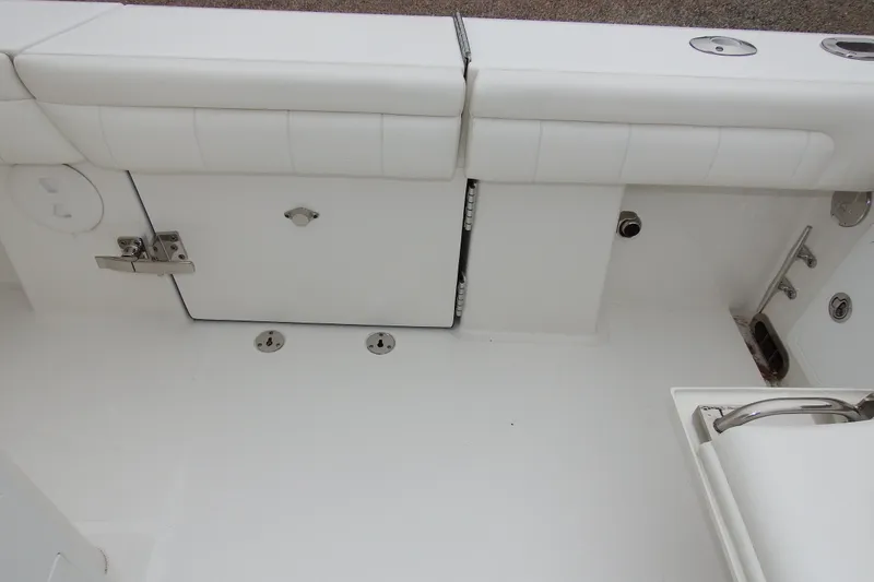 Slide: The Image of 2018 Regulator 34SS boat interior with white seating and storage compartments. - 10