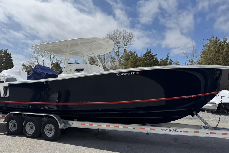 Slide: The Image of 2018 Regulator 34SS boat on trailer under cloudy sky. - 101