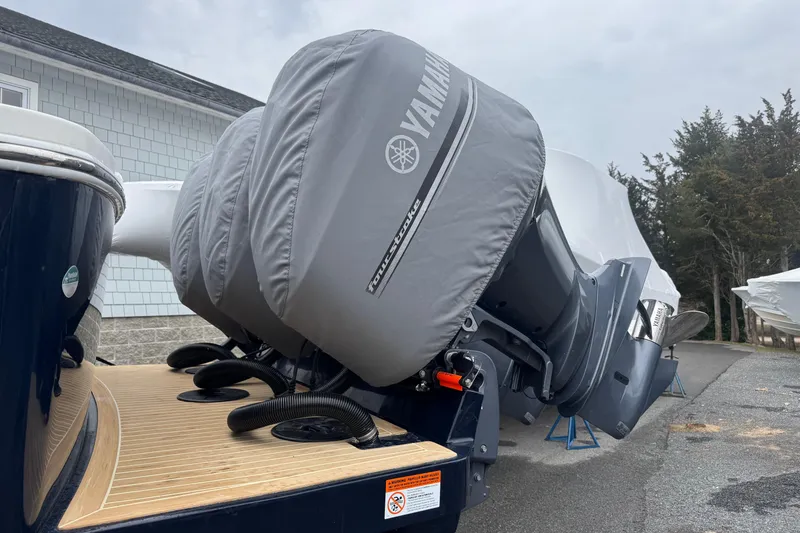 Slide: The Image of 2018 Regulator 34SS boat with Yamaha outboard engines covered, parked on a driveway. - 105