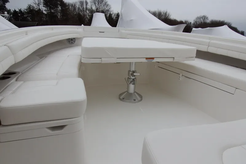 Slide: The Image of 2018 Regulator 34SS boat interior with white seating and table. - 16