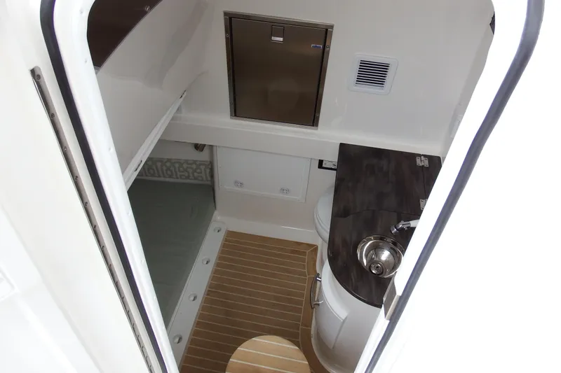 Slide: The Image of 2018 Regulator 34SS boat cabin interior with sink and storage. - 17