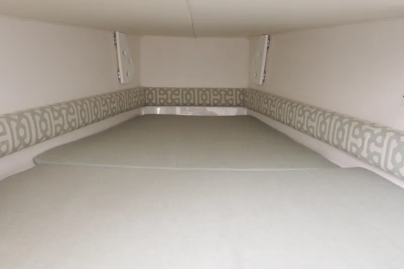 Slide: The Image of 2018 Regulator 34SS cabin interior with patterned cushions and neutral bedding. - 19