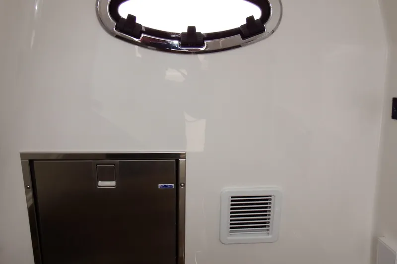 Slide: The Image of 2018 Regulator 34SS interior with porthole and stainless steel compartment. - 24