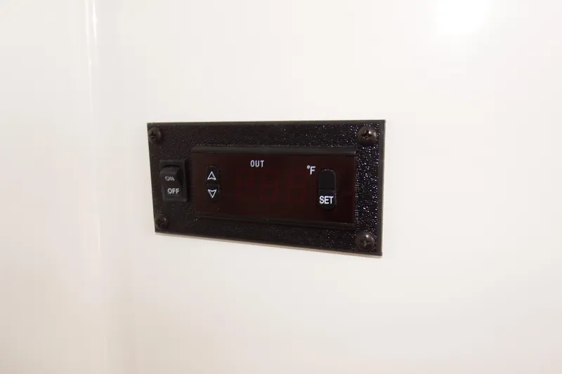 Slide: The Image of Control panel on 2018 Regulator 34SS boat, featuring temperature settings and on/off switch. - 25