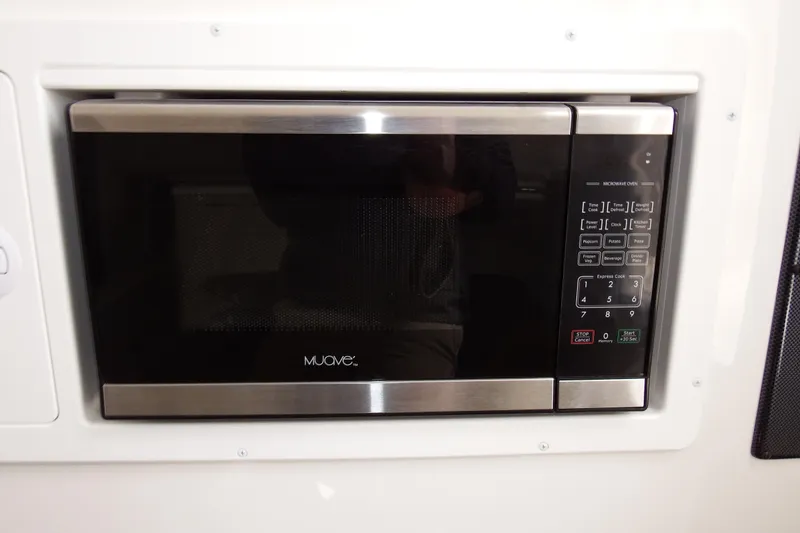 Slide: The Image of Built-in microwave oven on 2018 Regulator 34SS boat, featuring digital controls. - 26