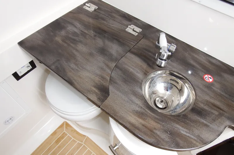 Slide: The Image of 2018 Regulator 34SS boat bathroom with sink and toilet. - 27