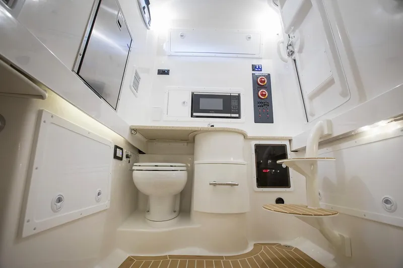 Slide: The Image of Interior view of a 2018 Regulator 34SS boat, featuring a stainless steel hatch and porthole. - 44