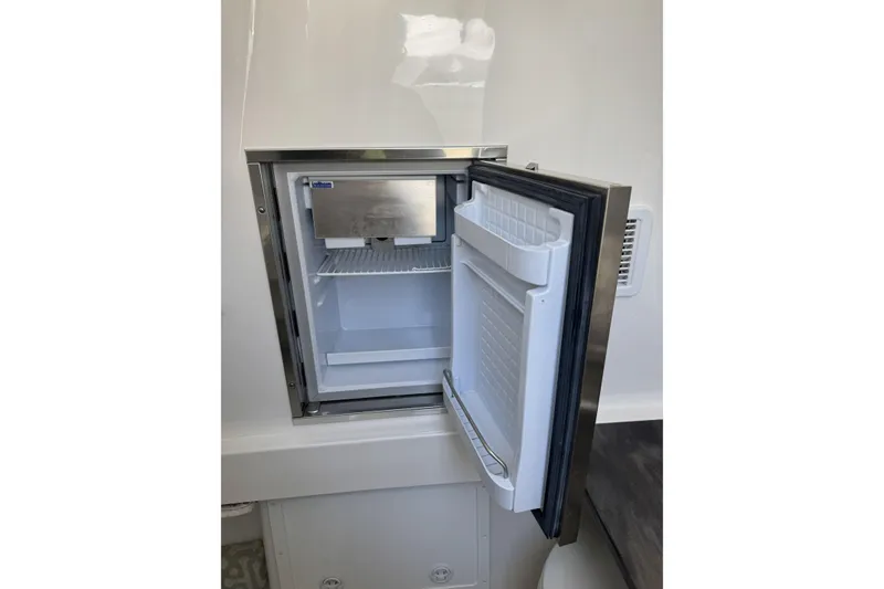 Slide: The Image of Open refrigerator on 2018 Regulator 34SS boat, showcasing interior storage space. - 47