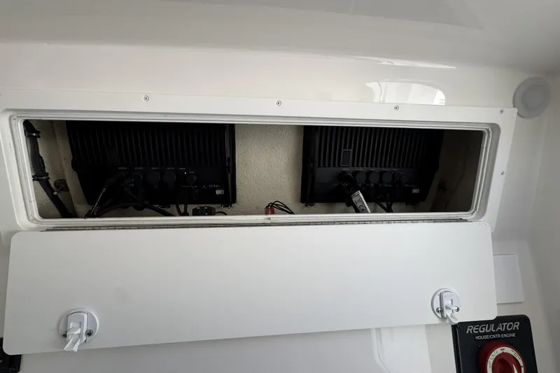 Slide: The Image of Electrical compartment of a 2018 Regulator 34SS boat, showcasing wiring and components. - 48