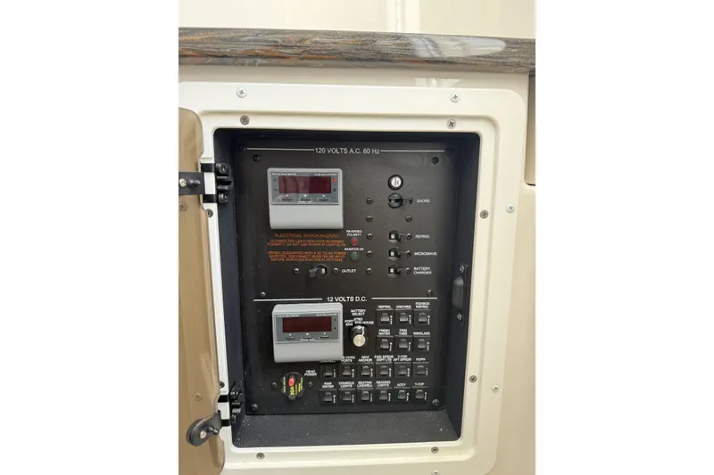 Slide: The Image of Electrical panel on a 2018 Regulator 34SS boat, featuring various switches and controls. - 50