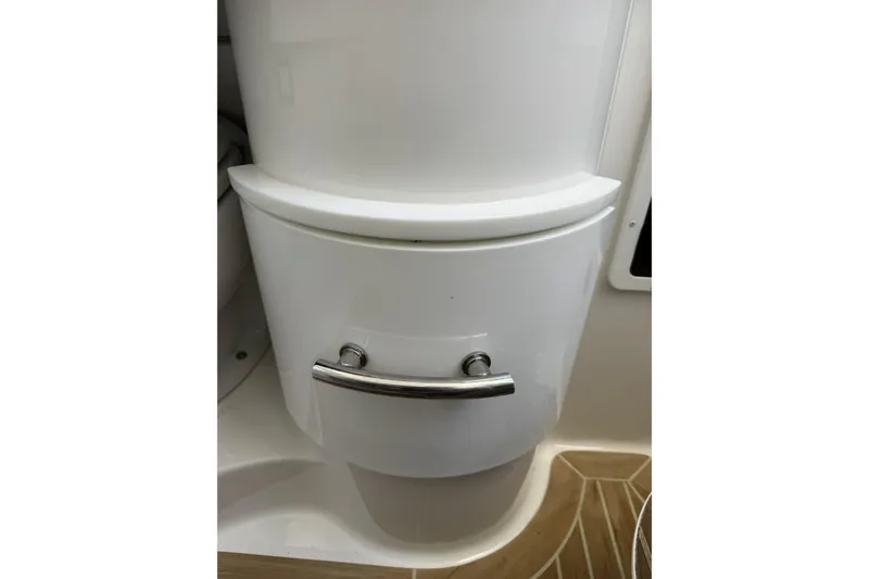 Slide: The Image of 2018 Regulator 34SS boat interior with sleek white cabinetry and chrome handle. - 51