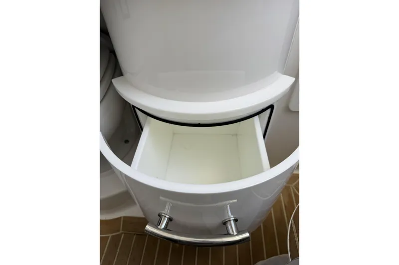 Slide: The Image of Open storage compartment on 2018 Regulator 34SS boat, featuring sleek design and chrome handle. - 52