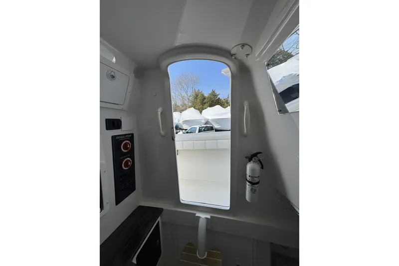 Slide: The Image of Interior view of a 2018 Regulator 34SS boat, featuring a doorway and control panel. - 55