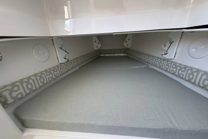 Slide: The Image of 2018 Regulator 34SS boat cabin interior with cushioned seating and storage compartments. - 56