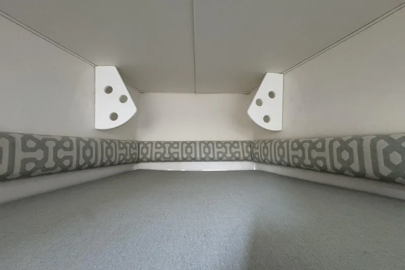 Slide: The Image of Interior cabin of 2018 Regulator 34SS boat with patterned cushions and white walls. - 58