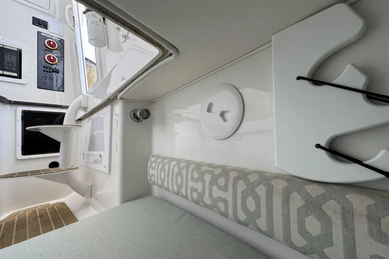 Slide: The Image of Interior of a 2018 Regulator 34SS boat, featuring seating and control panel. - 60
