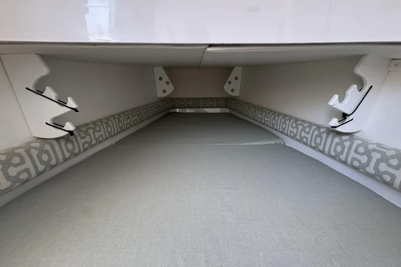 Slide: The Image of Interior view of a 2018 Regulator 34SS boat cabin with cushioned seating. - 63