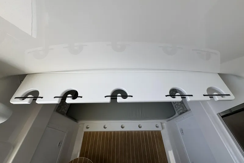 Slide: The Image of 2018 Regulator 34SS boat interior with rod holders and wooden flooring. - 64