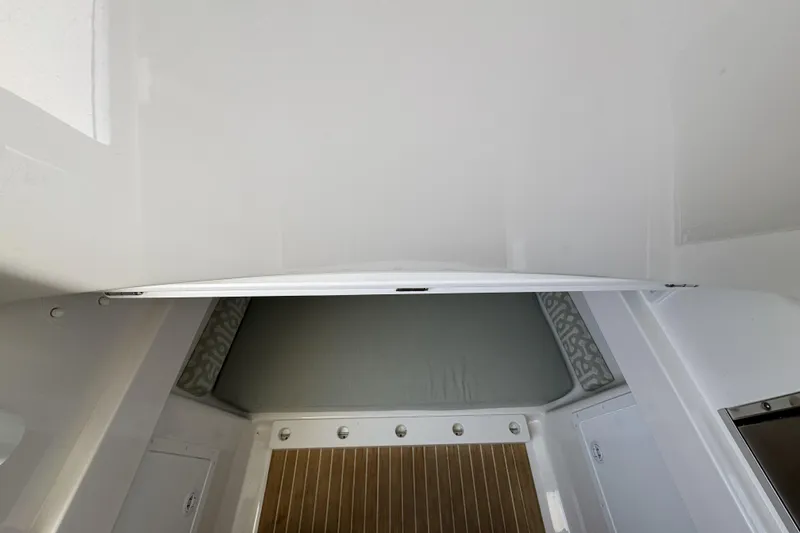 Slide: The Image of 2018 Regulator 34SS cabin interior with cushioned seating and wooden flooring. - 65