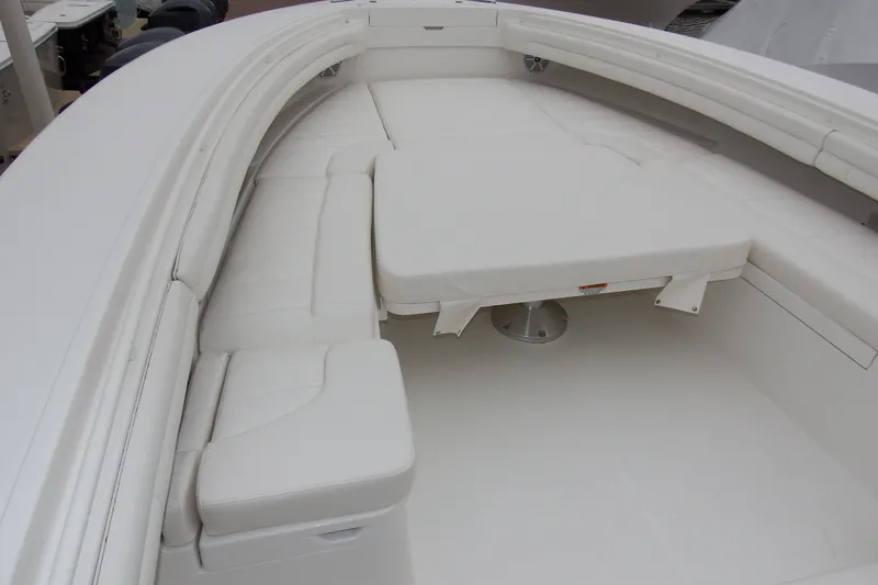 Slide: The Image of 2018 Regulator 34SS boat interior with white cushioned seating and table. - 7