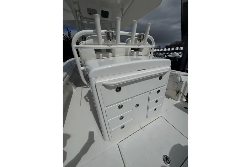 Slide: The Image of 2018 Regulator 34SS boat interior with storage compartments and rod holders. - 70