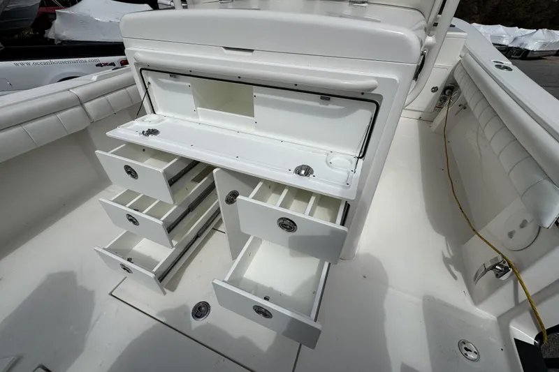 Slide: The Image of 2018 Regulator 34SS boat with open storage compartments and drawers. - 71