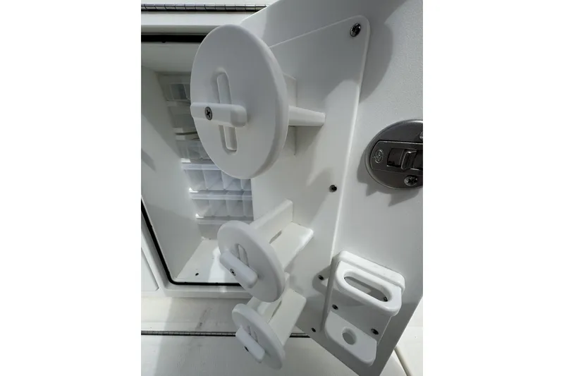 Slide: The Image of Interior view of a 2018 Regulator 34SS boat compartment with storage features. - 74