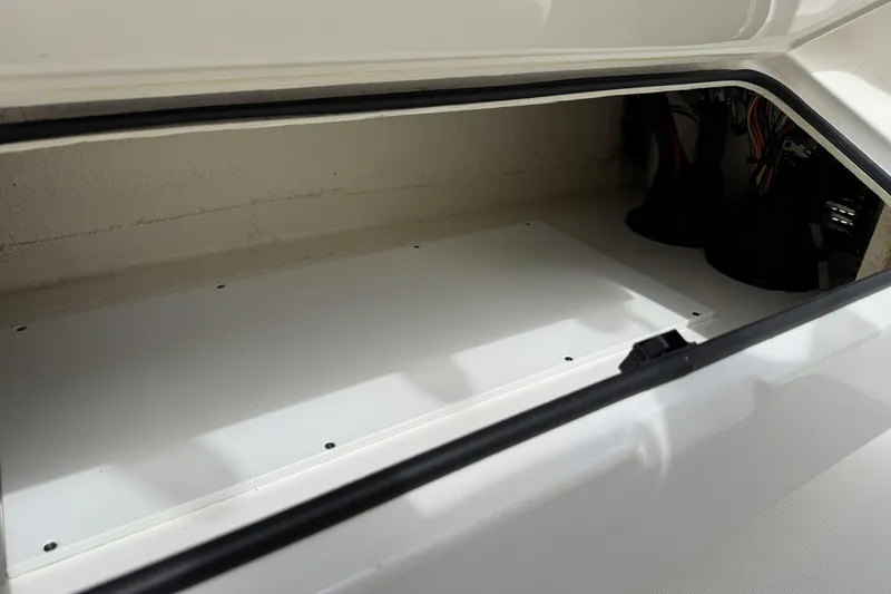 Slide: The Image of Storage compartment of a 2018 Regulator 34SS boat, showcasing interior space and wiring. - 82