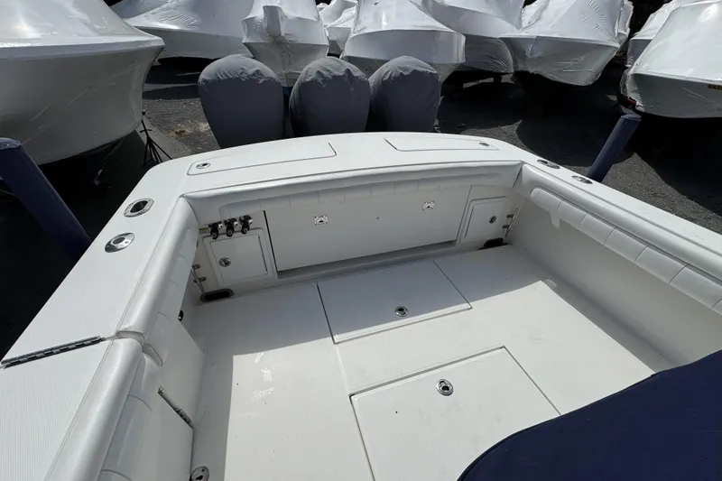 Slide: The Image of 2018 Regulator 34SS boat interior with storage compartments and covered engines. - 86