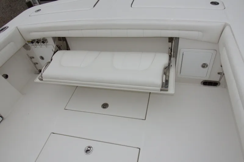Slide: The Image of 2018 Regulator 34SS boat with foldable white bench seat and storage compartments. - 9