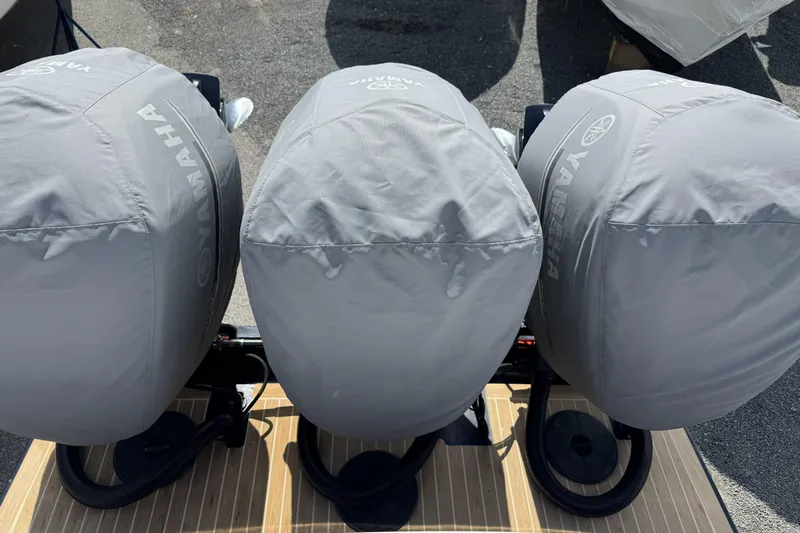 Slide: The Image of Triple Yamaha outboard motors covered, mounted on a 2018 Regulator 34SS boat. - 92