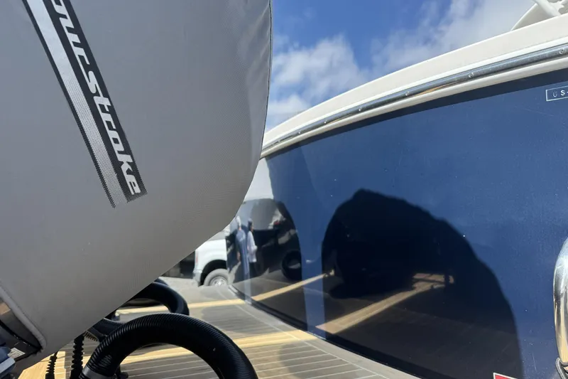 Slide: The Image of 2018 Regulator 34SS boat with outboard motor cover, reflecting blue sky. - 93