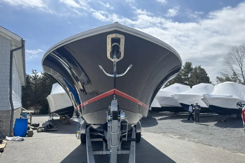 Slide: The Image of 2018 Regulator 34SS boat on trailer, parked outdoors under a cloudy sky. - 94
