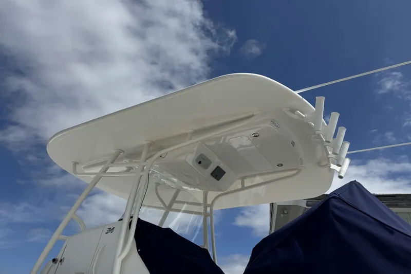 Slide: The Image of 2018 Regulator 34SS boat with T-top against a cloudy blue sky. - 97