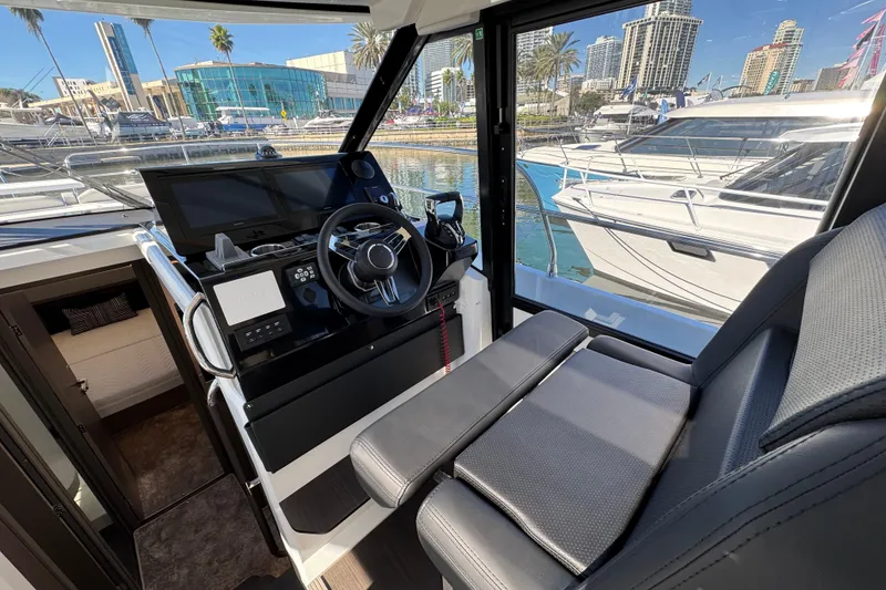 Slide: The Image of Interior view of 2026 Jeanneau NC 1295 Coupe yacht cockpit with modern controls. - 12