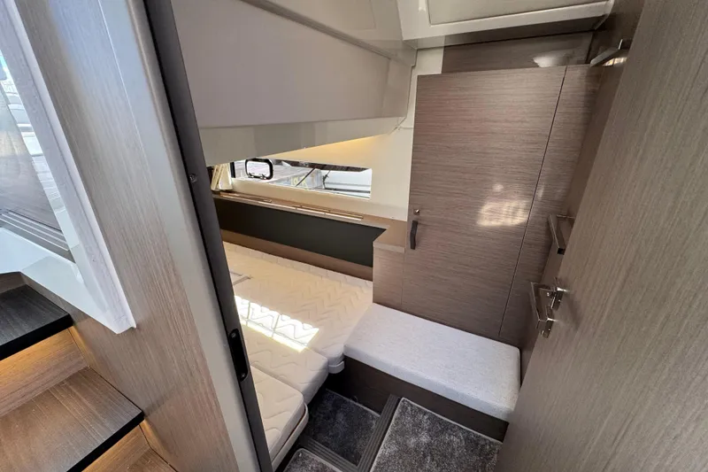 Slide: The Image of Interior cabin of 2026 Jeanneau NC 1295 Coupe, featuring modern design and cozy sleeping area. - 15