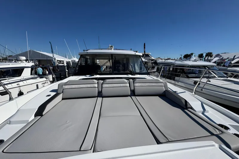 Slide: The Image of 2026 Jeanneau NC 1295 Coupe luxury yacht with spacious sunbathing area, docked at marina. - 22