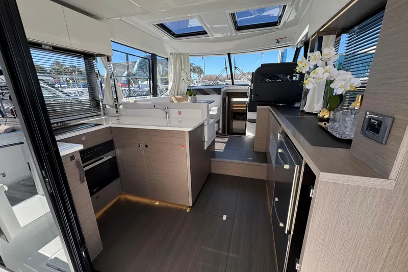 Slide: The Image of Modern interior of 2026 Jeanneau NC 1295 Coupe yacht with sleek kitchen design. - 7