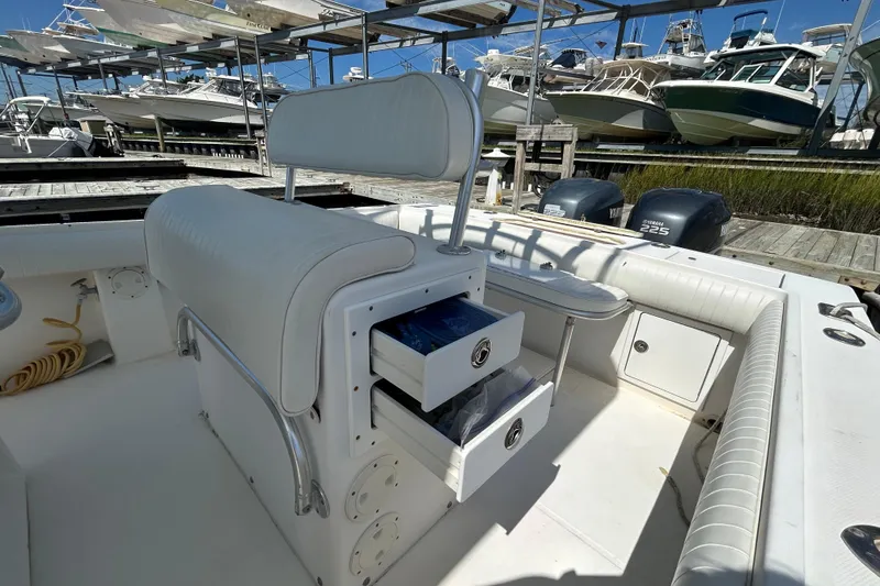 Slide: The Image of 2005 Regulator 26 Forward Seating boat interior with storage drawers and Yamaha engines. - 14
