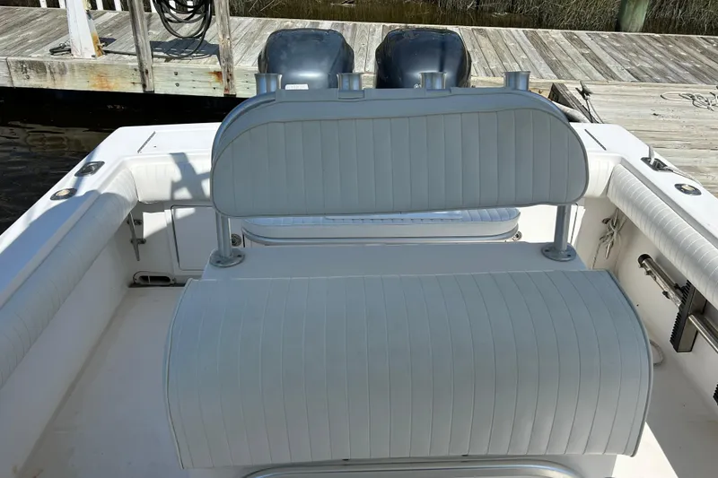 Slide: The Image of 2005 Regulator 26 Forward Seating boat interior with dual engines at dock. - 16