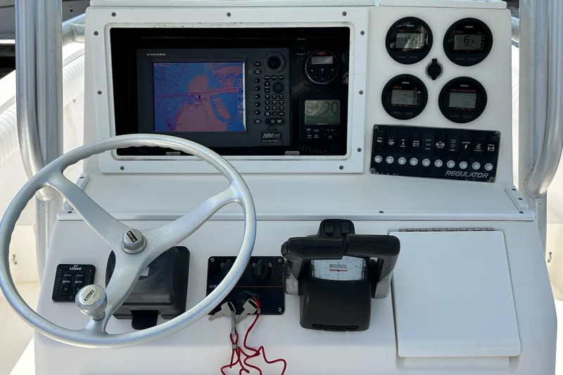 Slide: The Image of 2005 Regulator 26 Forward Seating boat dashboard with navigation and control instruments. - 18