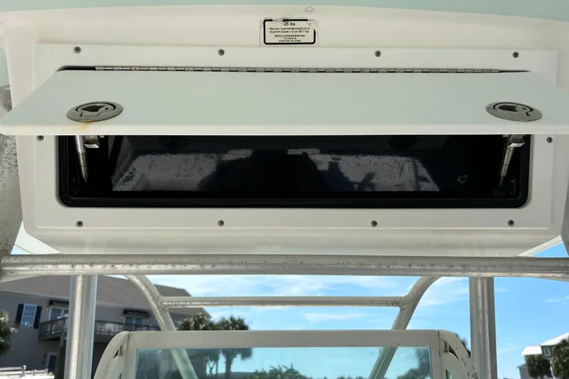 Slide: The Image of Open storage compartment on a 2005 Regulator 26 Forward Seating boat. - 23