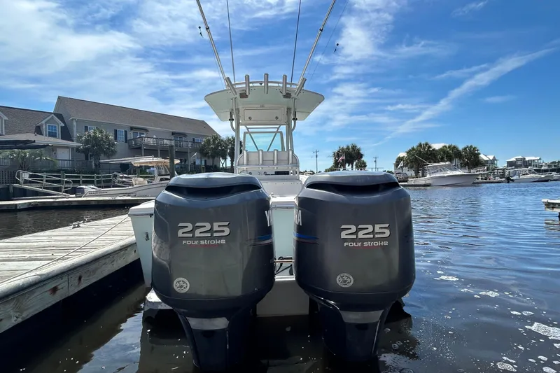 Slide: The Image of 2005 Regulator 26 Forward Seating boat with twin Yamaha 225 four-stroke engines at a marina. - 3