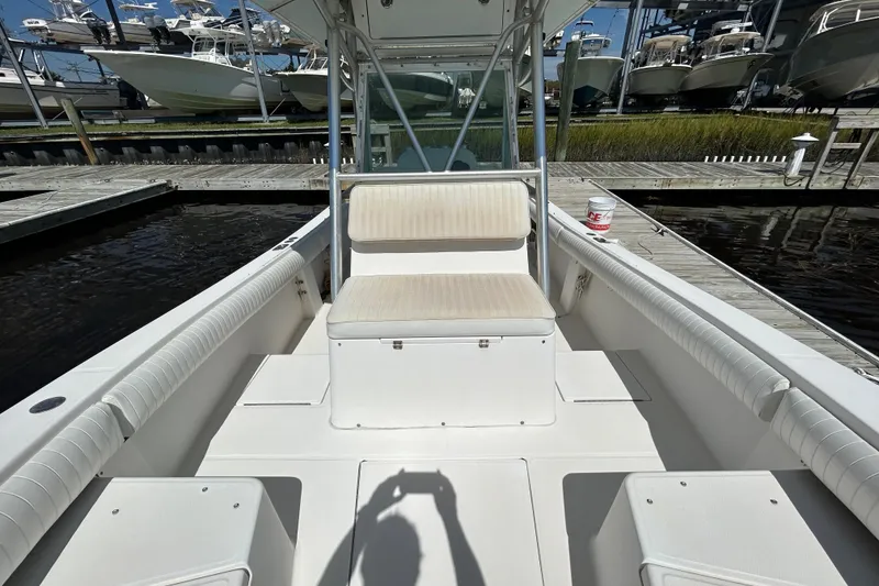 Slide: The Image of 2005 Regulator 26 Forward Seating boat interior at dock, showcasing seating and deck layout. - 30