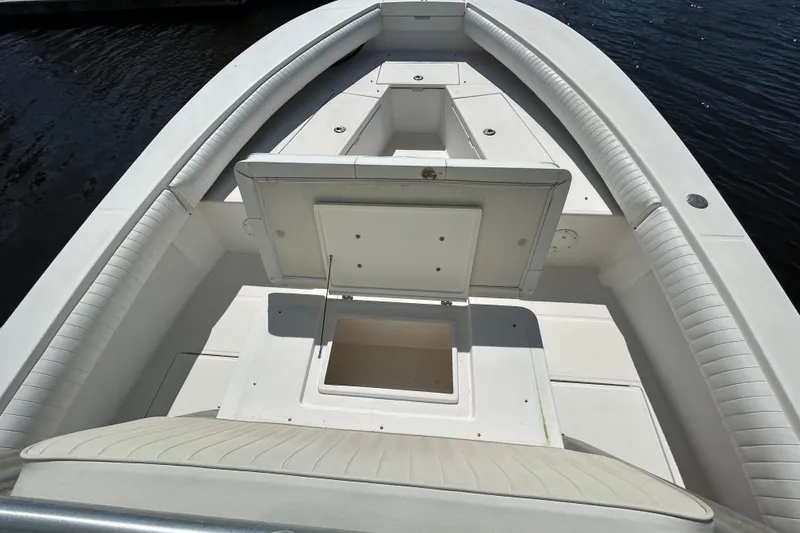 Slide: The Image of 2005 Regulator 26 Forward Seating boat interior with open storage compartments. - 32